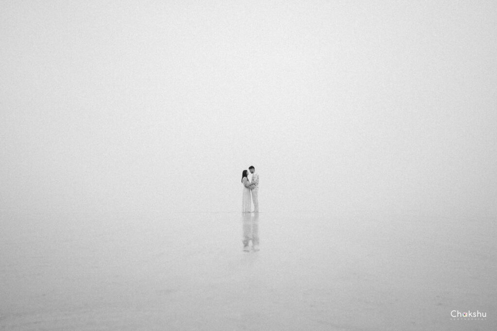 A man and woman enjoy a beach walk, embodying love and joy, as seen through the lens of a pre-wedding photographer in Delhi.