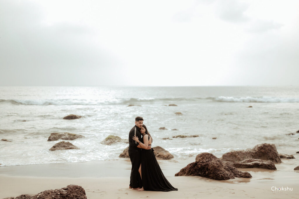 A couple enjoying a romantic moment on the beach, captured by a pre-wedding photographer in Delhi.