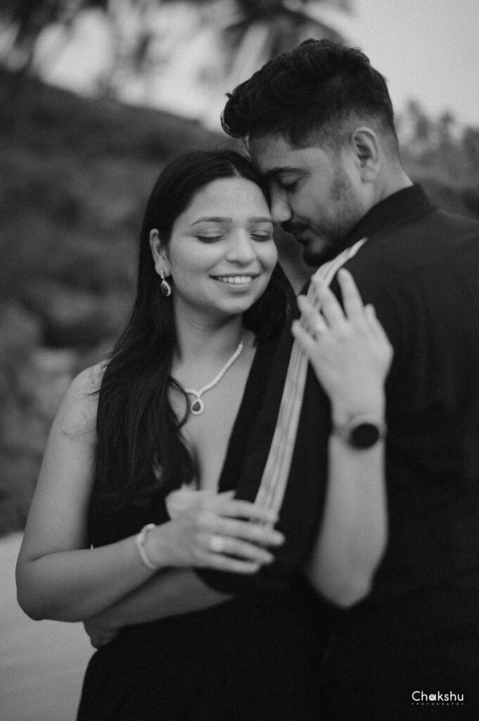 Couple standing in a black frame and groom huggs bride picture captured by the best pre-wedding photographer in Delhi