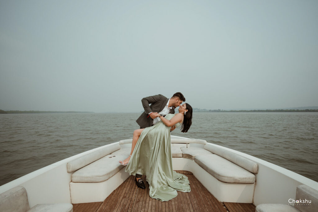 couple pose in a ship with sea view captured by wedding photographer in Delhi/NCR.