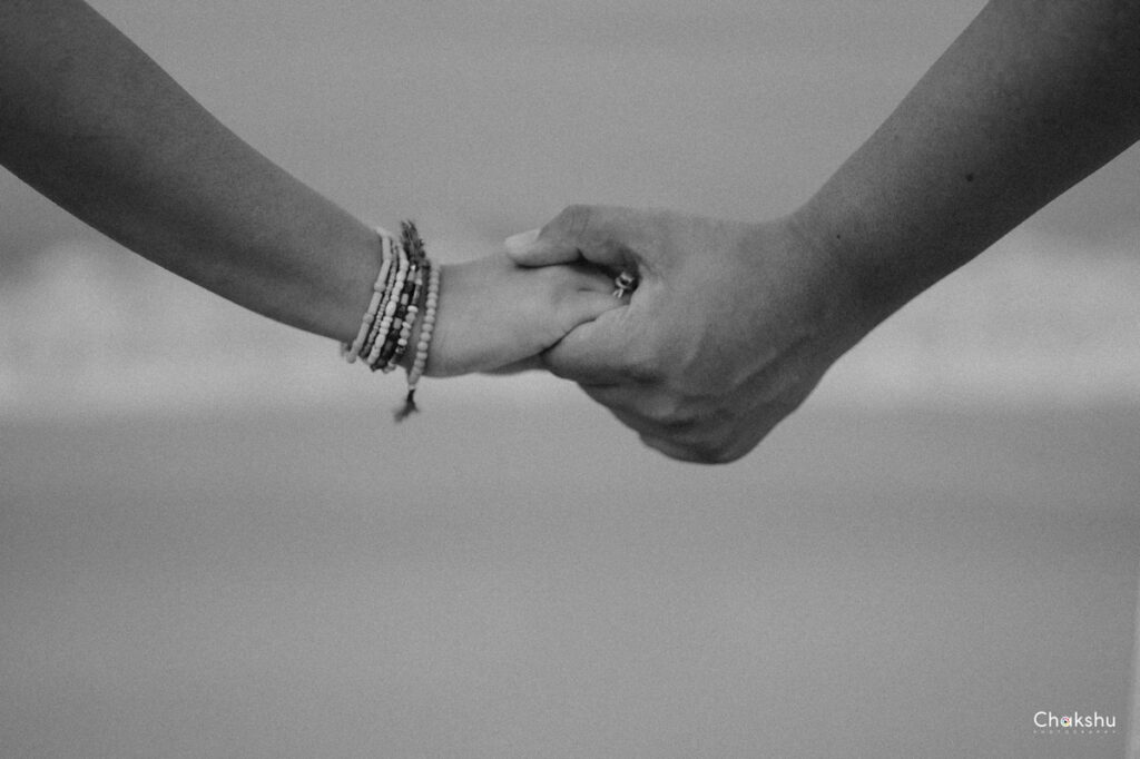 A couple walking hand in hand on the beach, expertly captured by a pre-wedding photographer in Delhi.