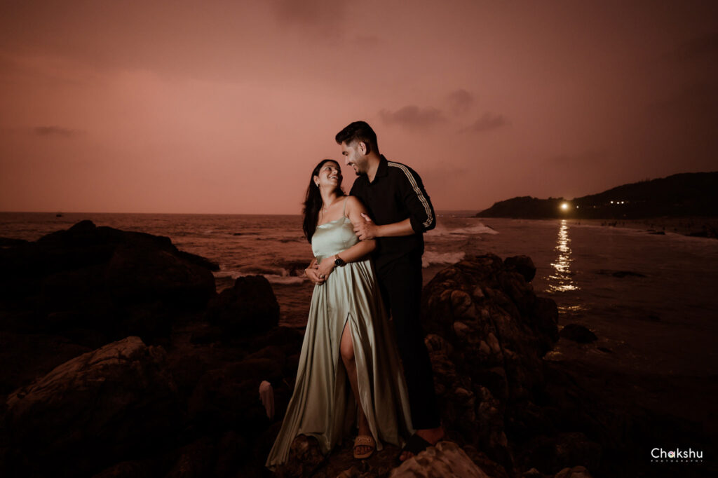 Pre wedding image of a cute couple standing on rock and staring to each other image captured by best pre- weeding photographer in delhi..